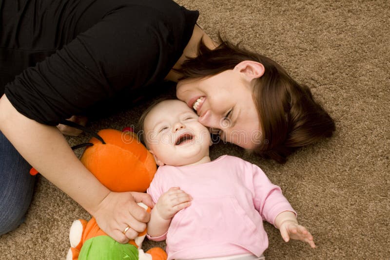 Mother and baby playing in home