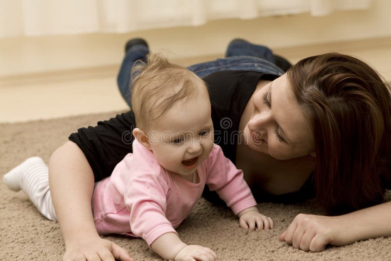 Mother and baby playing in home