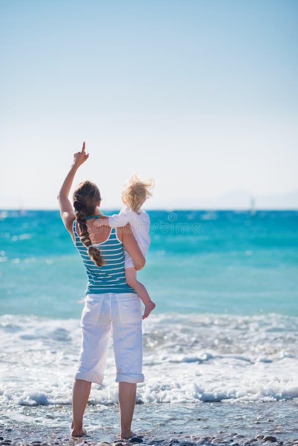 Mother and baby on sea coast