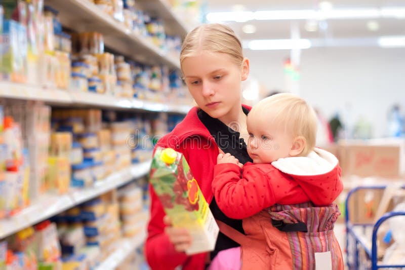 Mother with baby shopping in supermarket