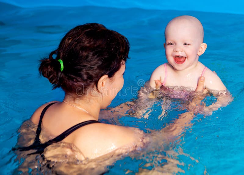 Mother and baby swimming