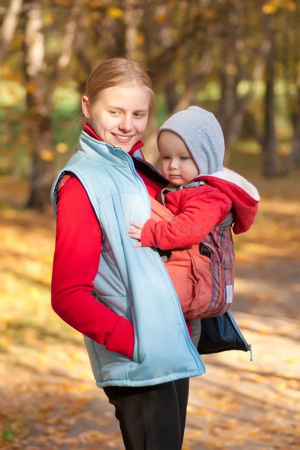 Mother carry toddler baby in park