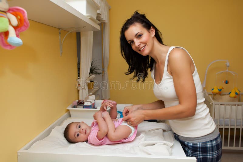 Mother changing diaper stock photo. Image of changing 15302130
