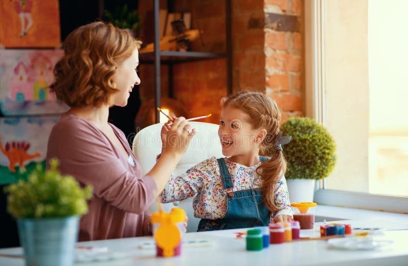 Mother and child daughter painting draws in creativity in kindergarten stock photo Mother and child daughter painting draws in creativity in kindergarten stock photo