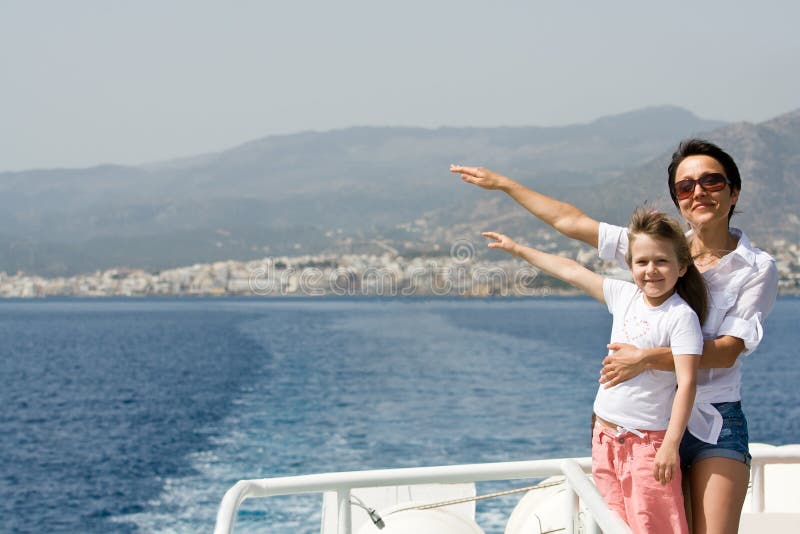 Mother, child enjoy wind and sea travel on boat