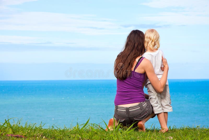 Mother and child looking at beautiful ocean view