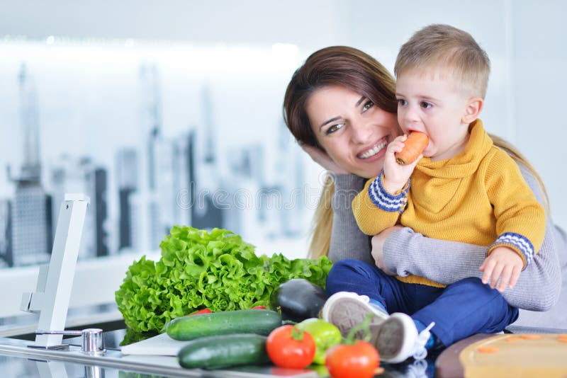 Mother and child preparing lunch from fresh veggies. Childhood, dinner.