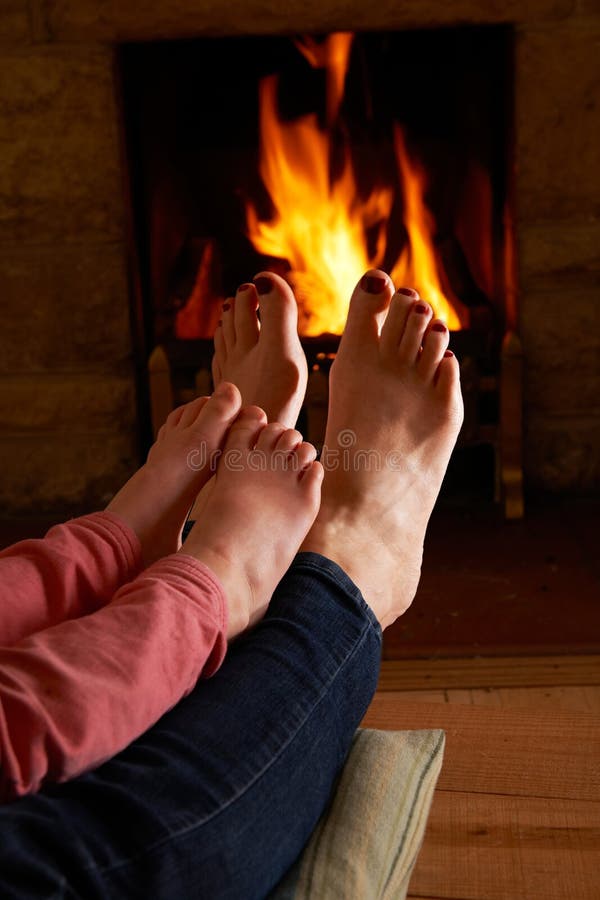Mother And Child Warming Feet By Fire royalty free stock image Mother And Child Warming Feet By Fire royalty free stock image