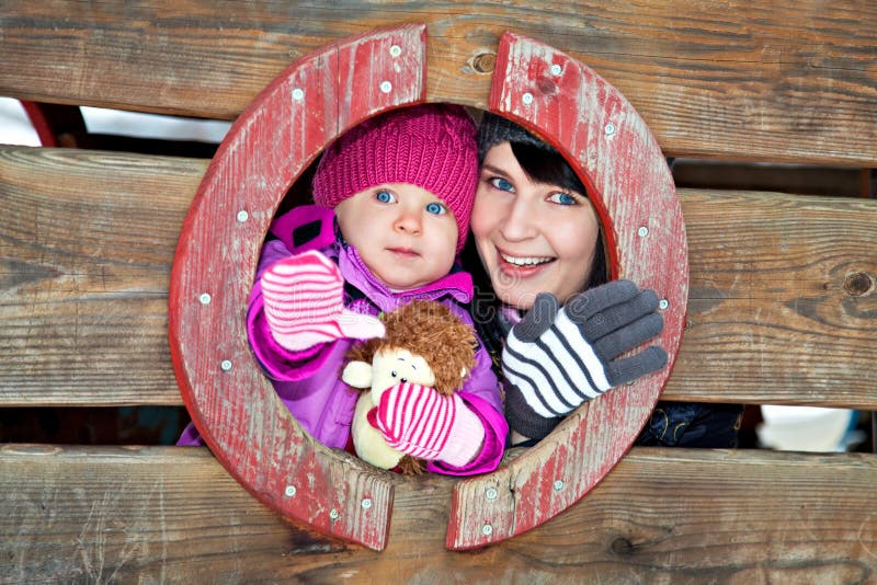 Mother and child on winter playground