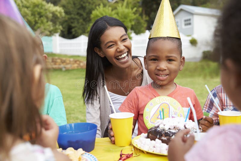 Mother With Children Enjoying Outdoor Birthday Party Together royalty free stock image Mother With Children Enjoying Outdoor Birthday Party Together royalty free stock image