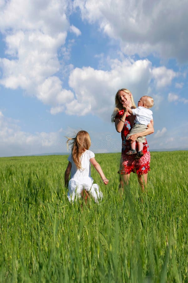 Mother and children in green field