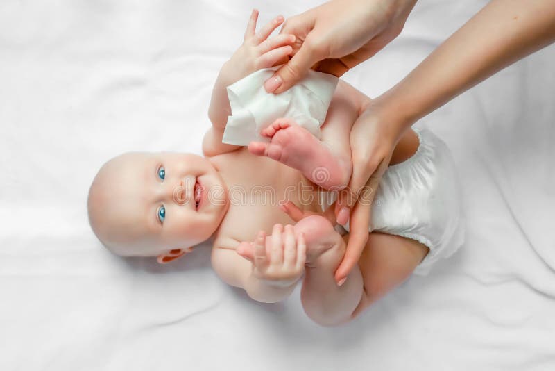 Mother cleaning up and wipes body and leg baby by wet tissue. Cleaning wipe, pure, clean. happy emotions of newborn baby