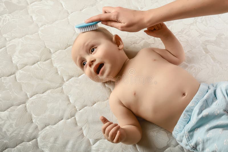Mother Combing Hair for Her Infant Baby Boy. Concept of Newborn Care. the  Baby Does Not Like To Comb Hair Stock Photo - Image of childhood, bathtub:  137475260