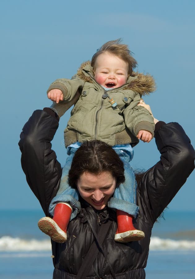 Mother and cute boy on the bea