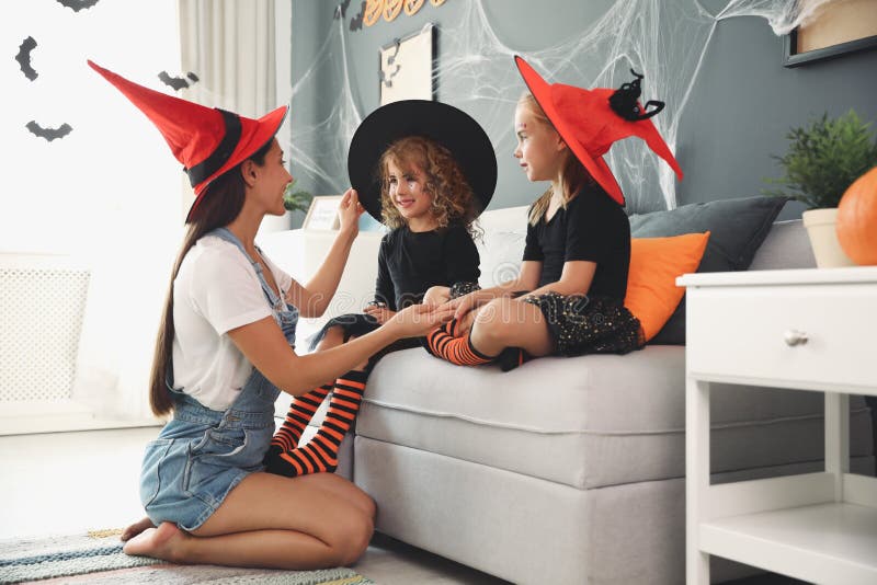 Mother and Cute Little Girls Wearing Halloween Costumes at Home Stock ...