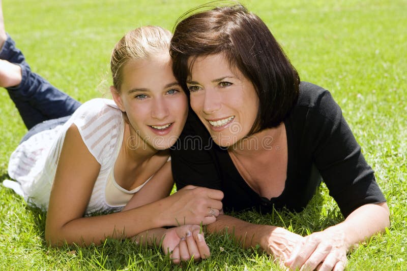 Woman Lying on the Ground with Teenage Daughter Stock Image Image of