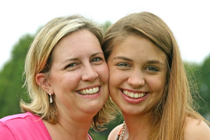 Mother and Daughter Smiling Big With Cheeks Together. Mother and Daughter Smiling Big With Cheeks Together