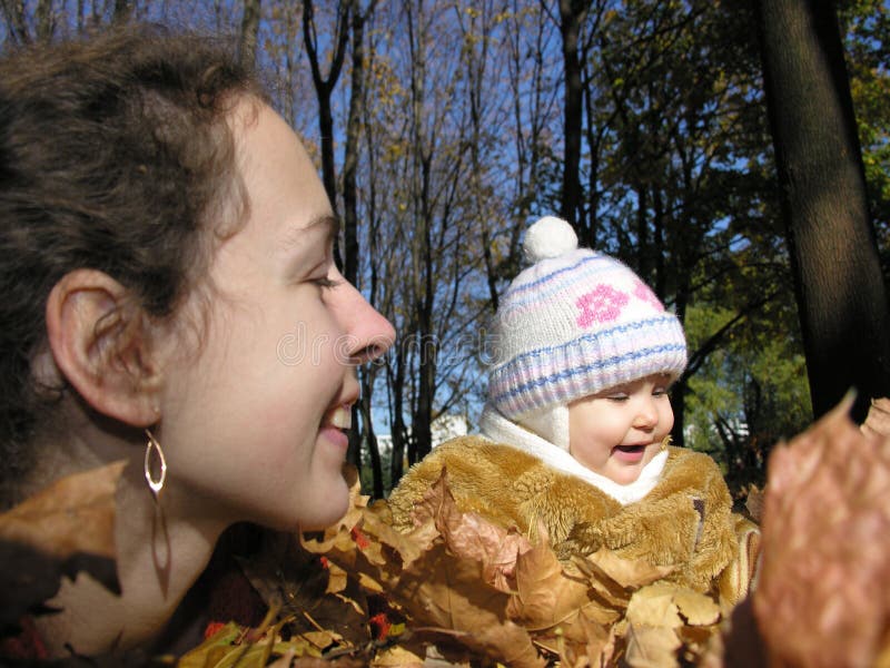 Mother with daughter in autumn wood