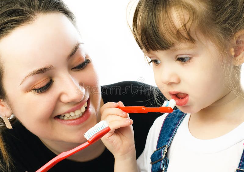 Mother and daughter brushing teeth