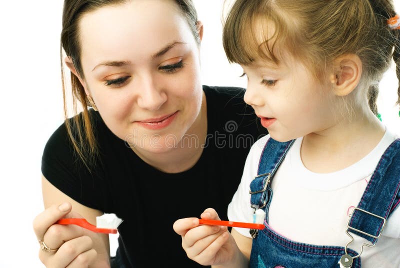 Mother and daughter brushing teeth