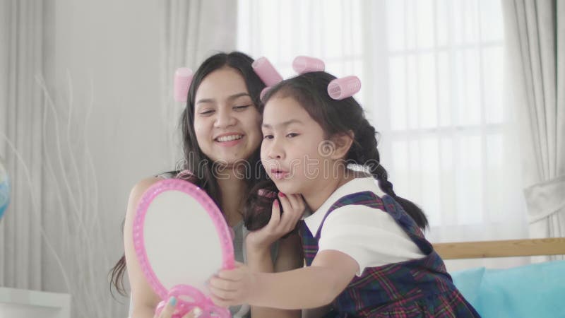 Mother And Daughter Doing Your Makeup Sitting On The Bed In The Bedroom Stock Video Video Of