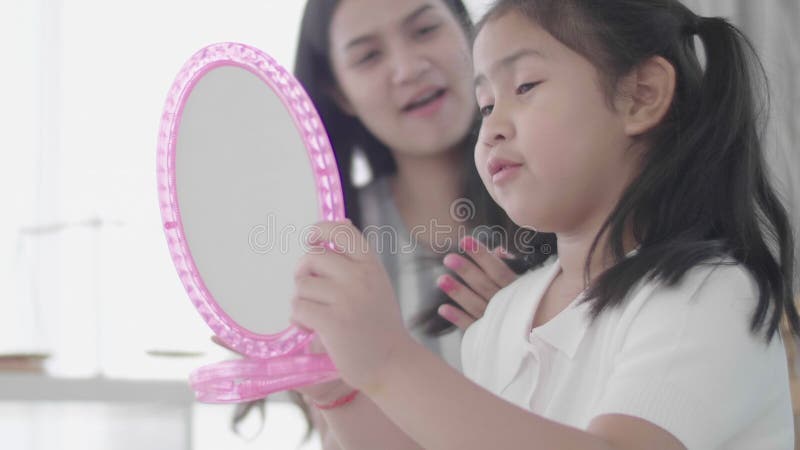 Mother And Daughter Doing Your Makeup Sitting On The Bed In The Bedroom Stock Footage Video