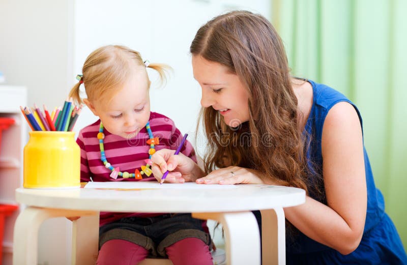 Mother and daughter drawing together royalty free stock photography