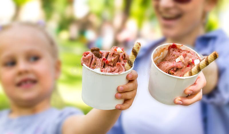 Mother and daughter eating ice cream stock images Mother and daughter eating ice cream stock images