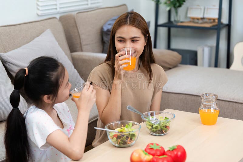 Wellness bonding: mother and daughter enjoying healthy drinks stock photos