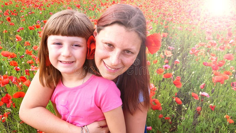 Mother and daughter into a field of poppies royalty free stock images