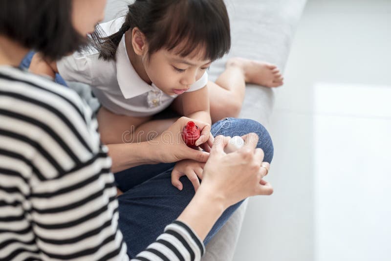 Mother and daughter having fun painting fingernails, family time concept royalty free stock photography Mother and daughter having fun painting fingernails, family time concept royalty free stock photography