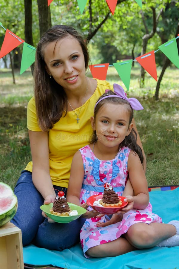 Mother and daughter having summer picnic