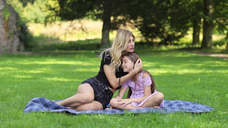 Mother and Daughter Hugging at a Picnic in the Park Stock Footage
