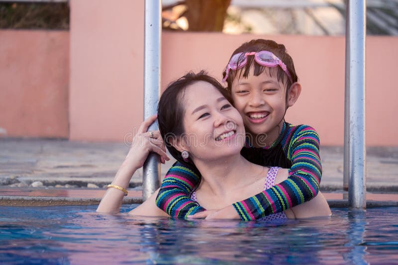 Mother And Daughter Playing In Swimming Pool Stock Image