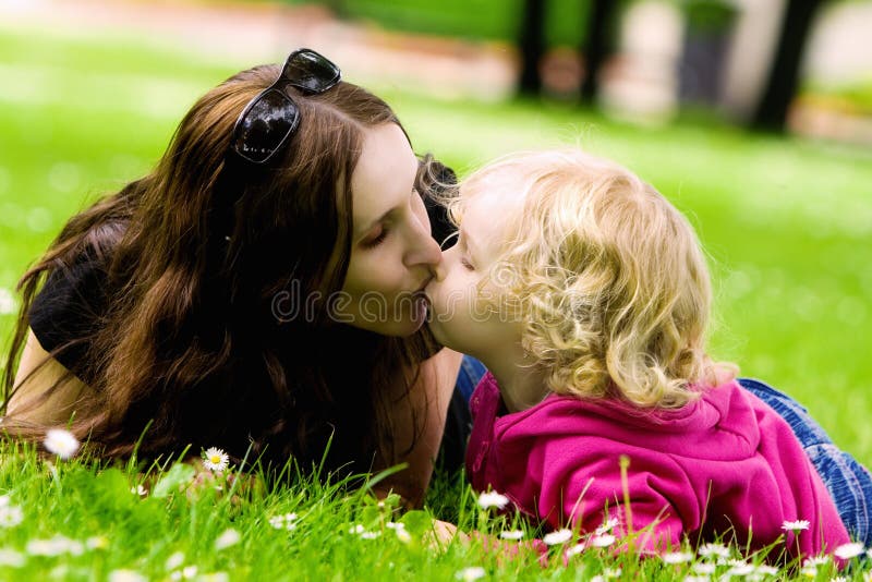 Mother and daughter kissing. 