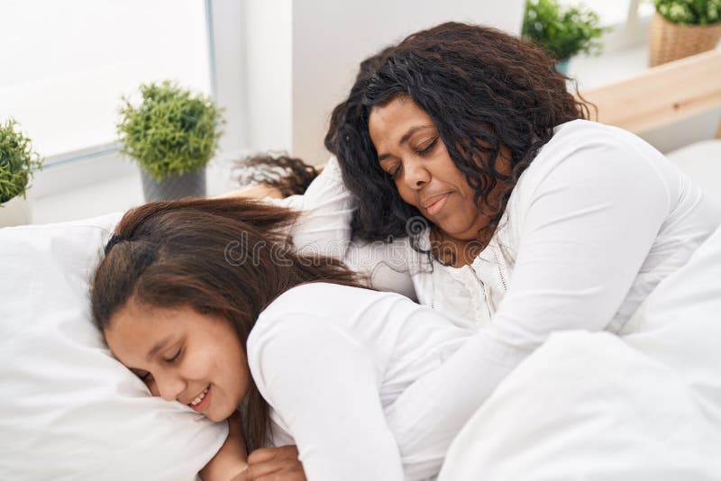 Mother and Daughter Lying on Bed Sleeping at Bedroom Stock Image