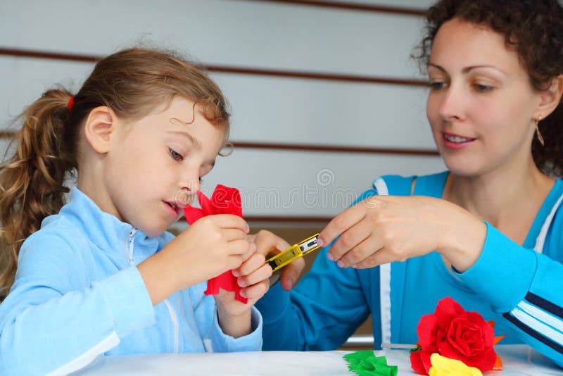 Mother and daughter make artificial roses