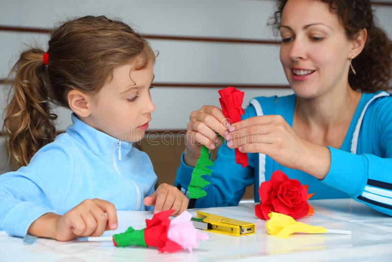 Mother and daughter make artificial roses