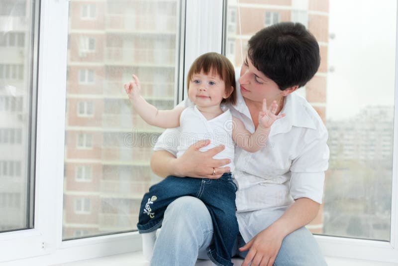 Mother and daughter near window