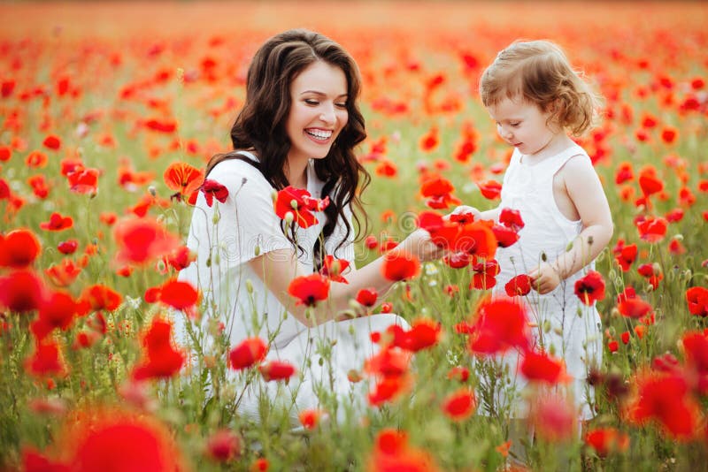 The Eldest Daughter Walks Down The Flower Path Mother and Daughter Playing in Flower Field Stock Photo - Image of