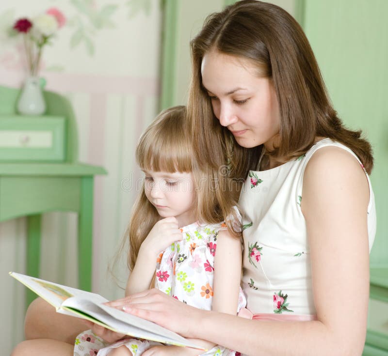 Mother with the daughter read the book royalty free stock photo