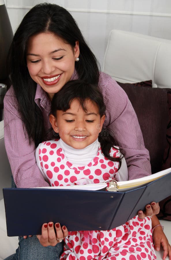 A mother and daughter reading book stock image