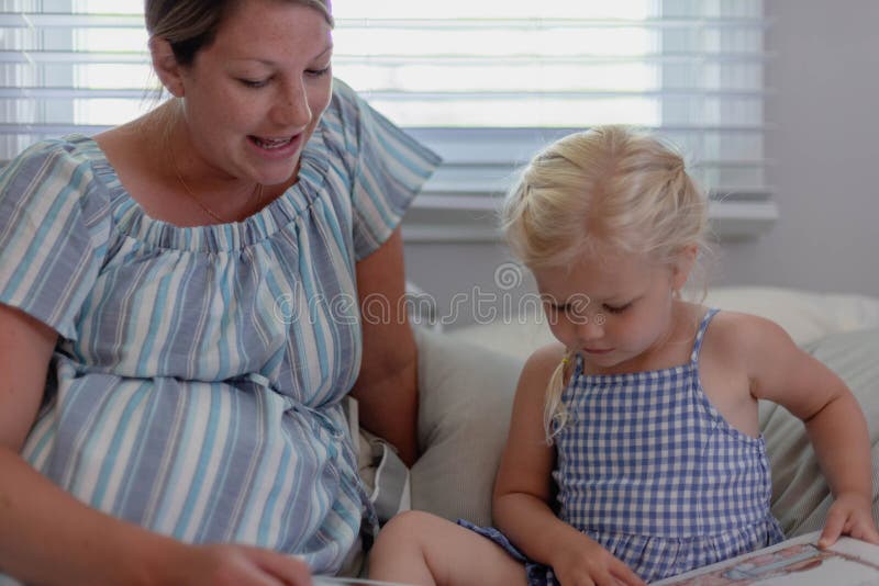 Mother and daughter reading a book together stock images Mother and daughter reading a book together stock images
