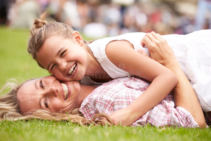 Mother And Daughter Relaxing At Outdoor Summer Event