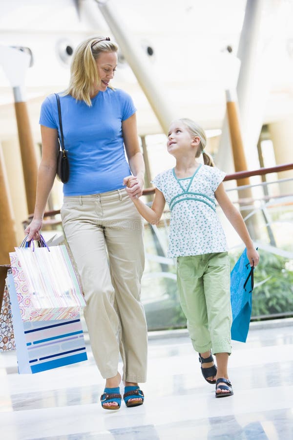 Mother and daughter shopping in mall royalty free stock images