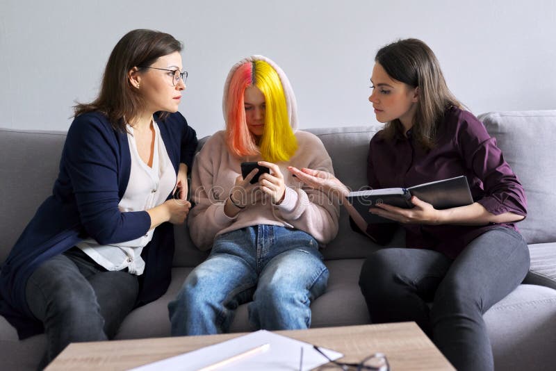 Mother and daughter teenager at consultation with psychologist, problems of adolescence, parent child relationship. Family, mental health, therapy, teenager, help of professional counselor