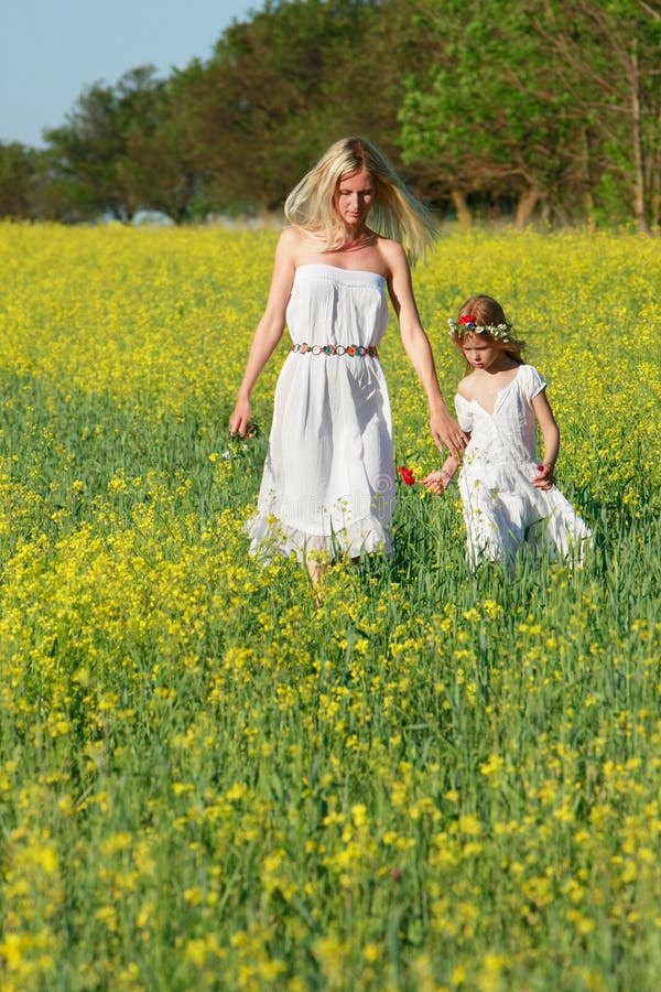 Mother and daughter in traditional clothes walking