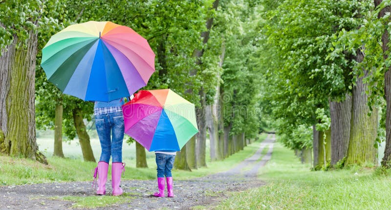 Mother and daughter with umbrellas