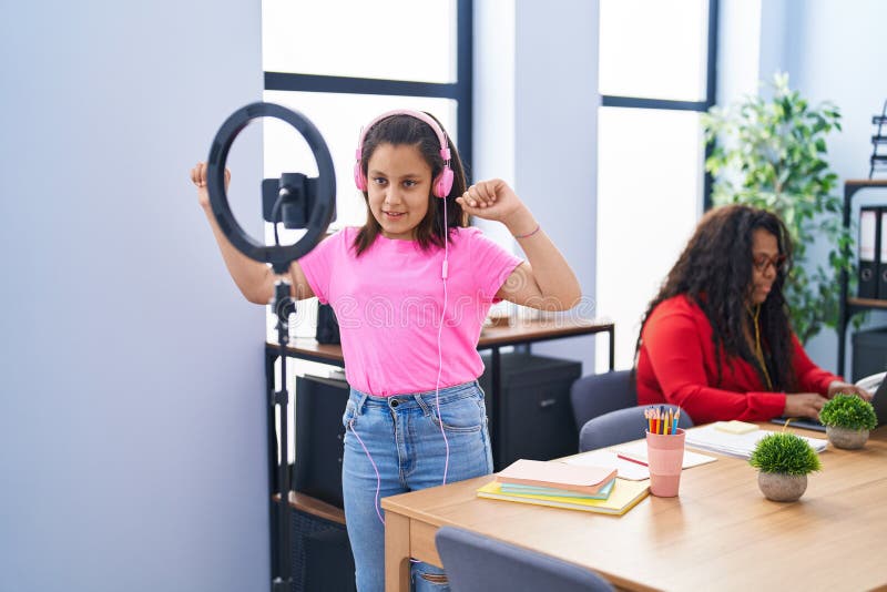 Mother and Daughter Working and Recording Dance Video at Office Stock
