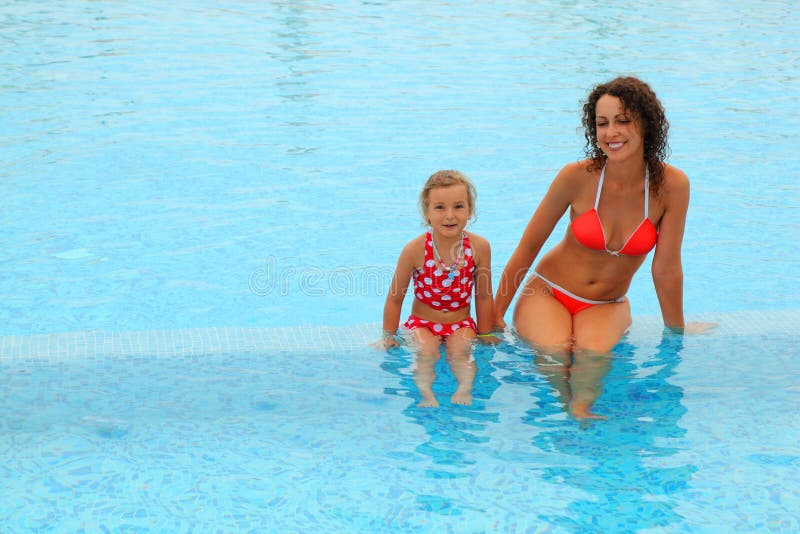 Mother and daugther sitting in open pool